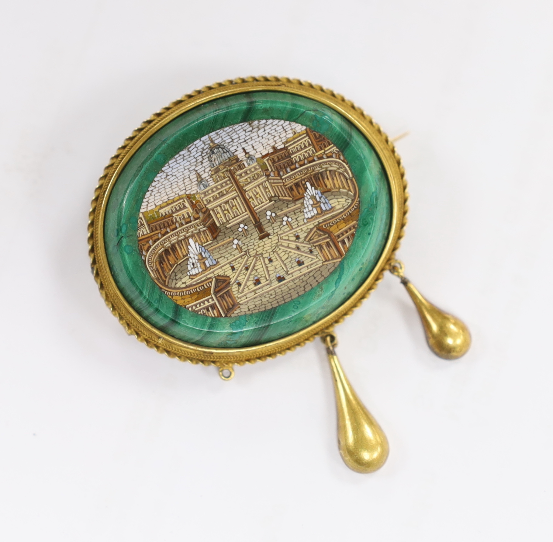 A Victorian yellow metal mounted malachite micro mosaic drop brooch, width 44mm, gross weight 21 grams, depicting St. Peters in Rome, (lacking drop).